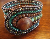 Leather cuff wrap bracelet with 7 rows of czech glass beads in blues and brown with handmade copper button
