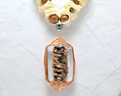 Wire wrapped glass bead. Gold and black pendant. Ivory ribbon necklace. Copper beads and wire. Black glass pearls. Beaded ribbon jewelry.