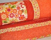 Handmade, queen, brightly colored quilt with flowers, geometric and bird fabric a traditional pattern with a modern country twist.