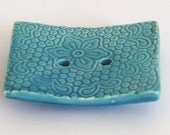 Home Decor handmade soap dish, made of clay and glazed with a shiny turquoise hue. The rectangular soap dish is decorated with a unique lace