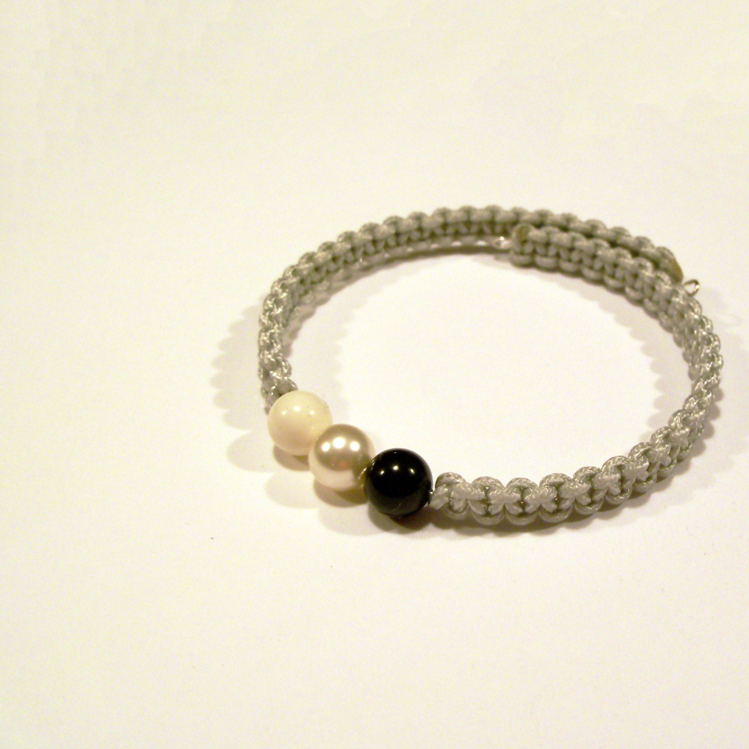 Black and white Swarovski pearl bracelet with light fog gray braided rope on adjustable memory wire