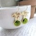 A Matte Gold Plated Orchid Flower Olivine Green Glass Framed Jewel French Drop Earrings. Bridesmaid Gifts. Modern Everyday Jewlery