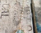 Gold edged rutilated green Agate pendant necklace with wire wrapped aquamarine stone