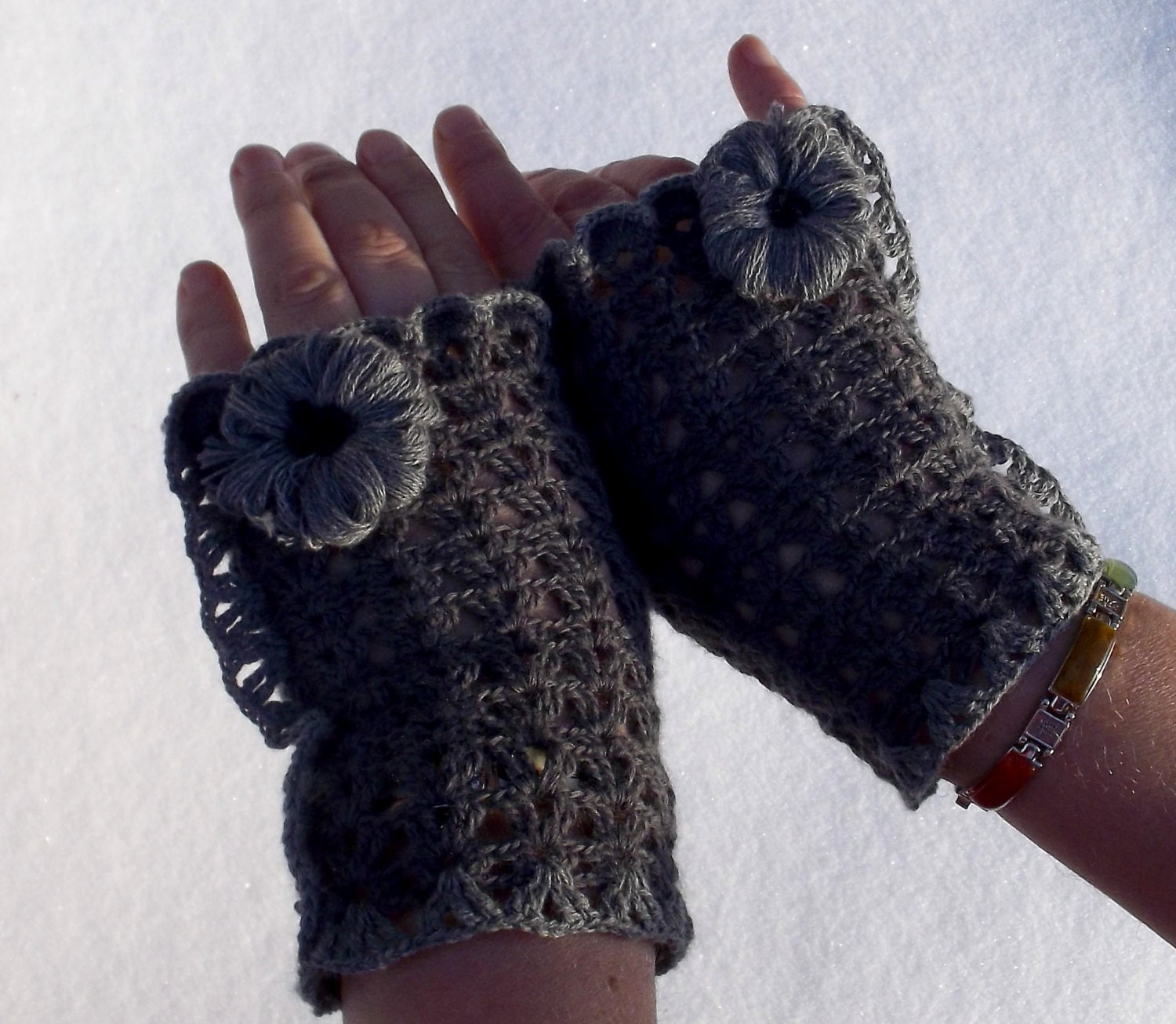 crocheted gray lace fingerless gloves with gray yarn flower for women.