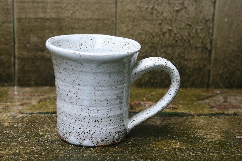 White rustic speckled ceramic mug, minimal kitchen tableware.