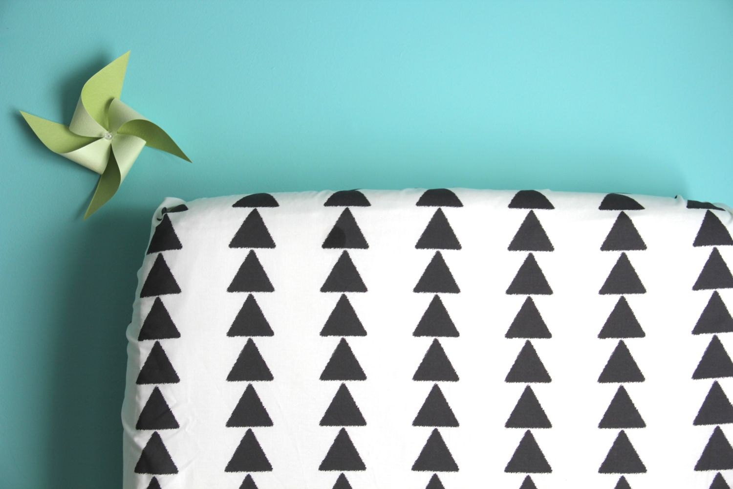 fitted crib sheet in triangle row on cream