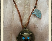 Owl Locket Necklace with other details on a leather strap.