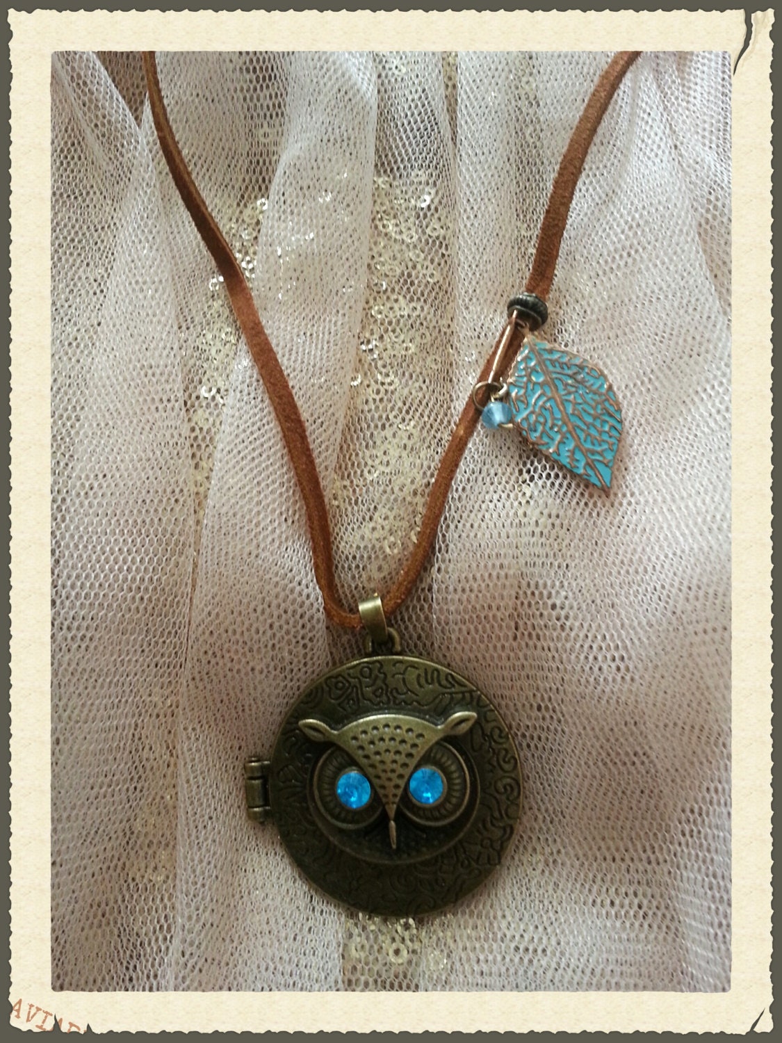 Owl Locket Necklace with other details on a leather strap.