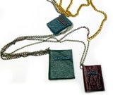 Book necklace, three decorative leather journals on chains.