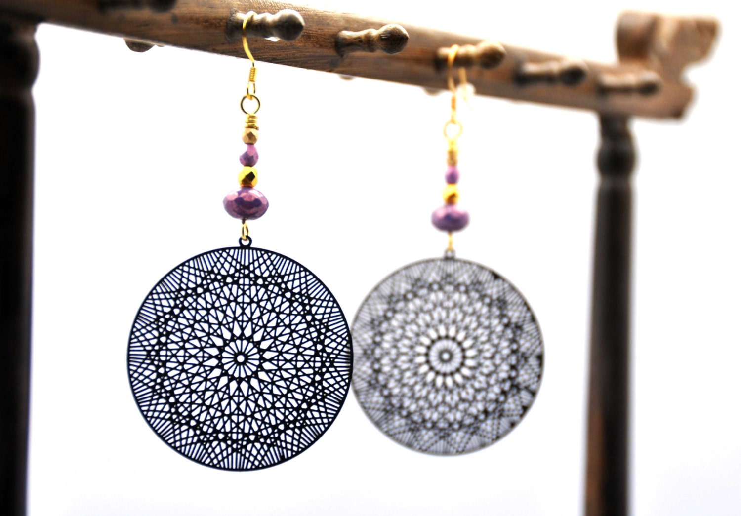 Delicately delightful earrings, made with black lasercut filigrees and lavender purple and gold faceted czech crystal beads