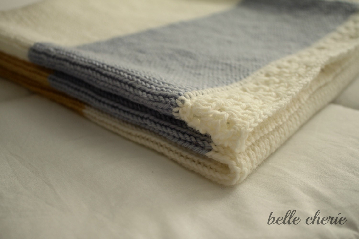 100% wool, knitted stripe blanket in blue, cream and gold