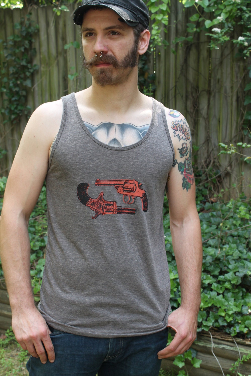 Dueling Victorian revolvers in orange on a brown unisex tank top