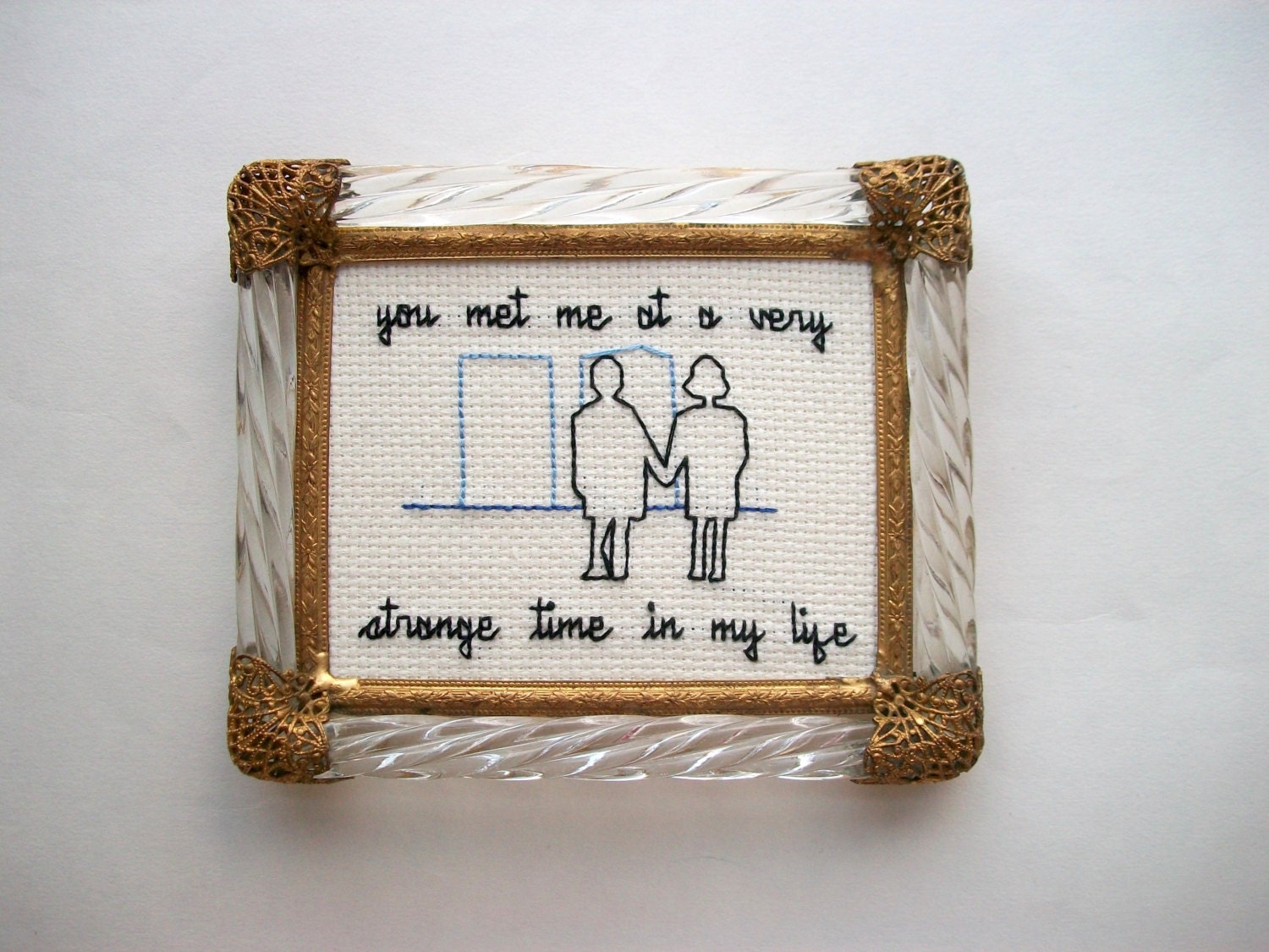 Very Strange Time cross stitch -- inspired ironic, simple cross stitch, minimalist with two people and some buildings
