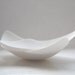 Set of 2 pure white stoneware English fine bone china vessels in an abstract boat shape.