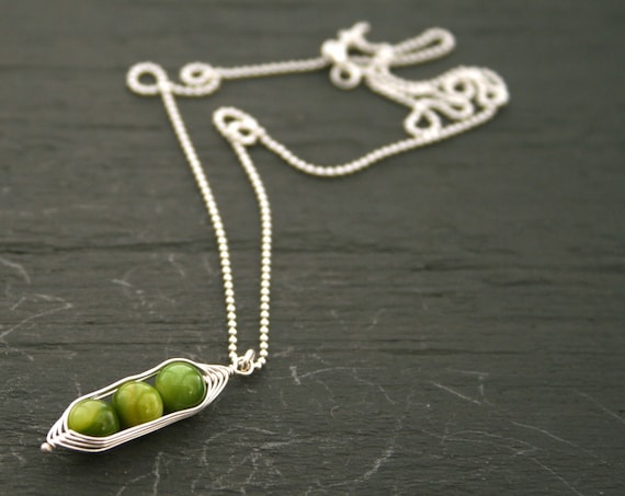 Three peas in a pod, green mother of pearl peapod pendant necklace on sterling silver chain.