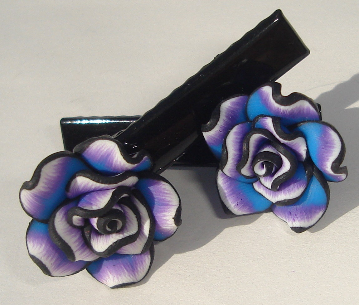 set of 2 hair clips with purple, black, blue, and white polymer clay flower embellishments