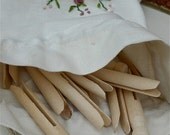 Old fashioned style peg bag with flower ribbon embroidery and 24 wooden dolly pegs.