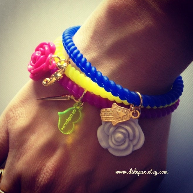 SET of THREE stretching Plastic neon bracelets with charms 