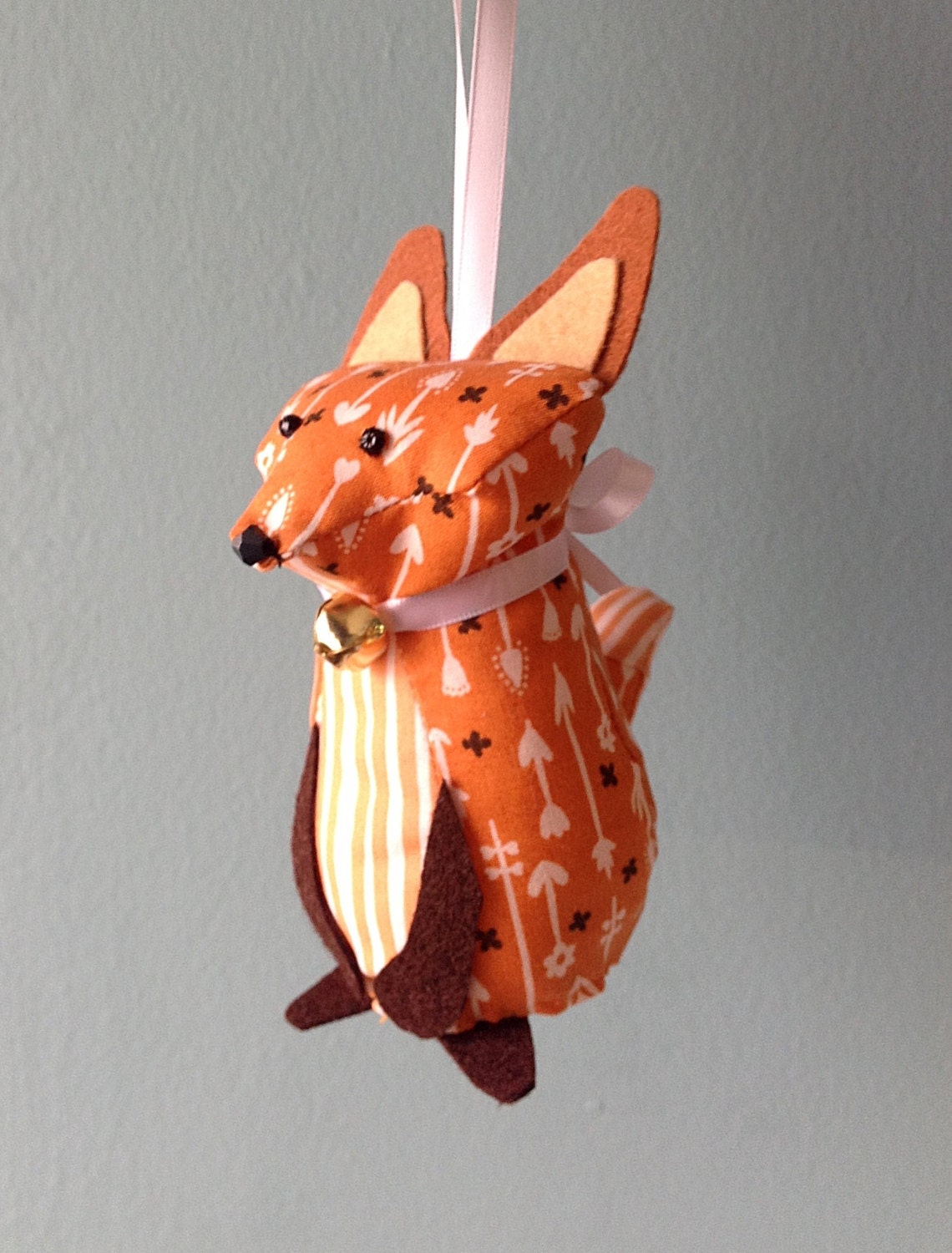 Small orange and white fox ornament with a bell