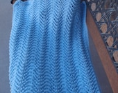 Soft, hand knitted, blue baby blanket for a special little boy