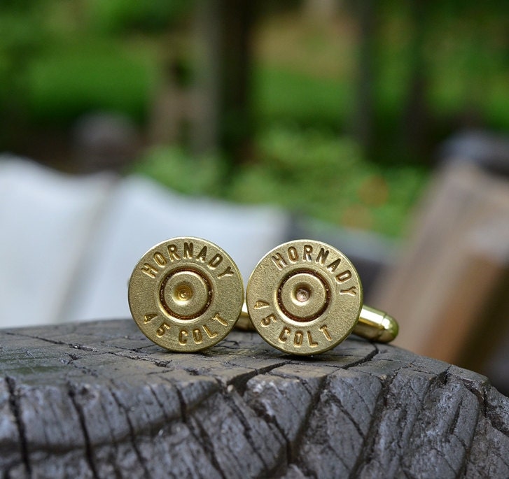 Bullet cufflinks fashioned from repurposed gold/brass Hornady .45 Long Colt shell casings