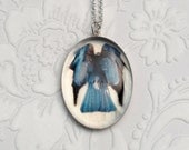 Luminous Crow Ascends Like a Dark Angel in Sterling Silver and Resin Oval Pendant with Fine Art Image Transfer and Resin