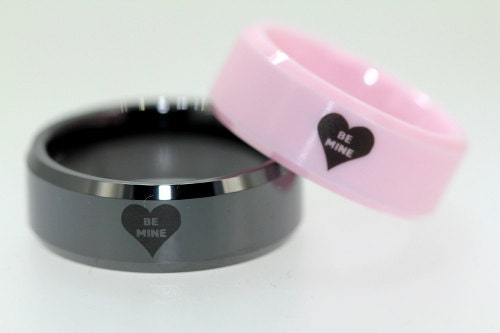 Valentine Ring with Laser Engraved Hearts with the words BE MINE inside the Heart One Black Ring or a Pink Ring