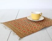 vintage straw table mat. 1970s hand woven placemat. Red, green, natural, fringed trivet. Boho tribal home decor / the FLAPJACK BASKET mat