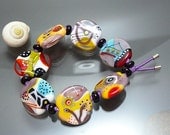 Melanie Moertel Lampwork Beads - Elastic bracelet with 7 handmade glass beads in purple, yellow, red and turquoise