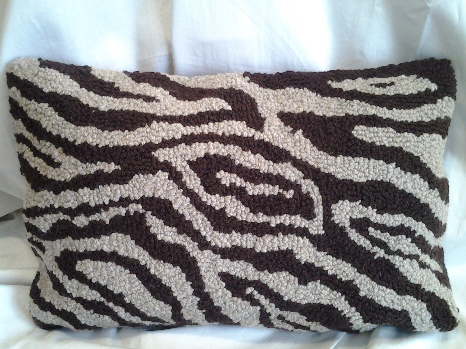 Handmade wool hooked pillow in faux bois pattern.  Natural and chocolate brown.