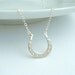 silver horseshoe necklace. lucky charm jewelry. good luck. sterling silver. simple everyday. equine. equestrian. horse shoe pendant.