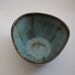 green triangular bowl with brown accents