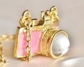 Pink and gold camera charm on bright gold chain