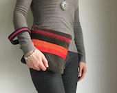 Large clutch wristlet in dark olive green corduroy with red orange and purple stripes