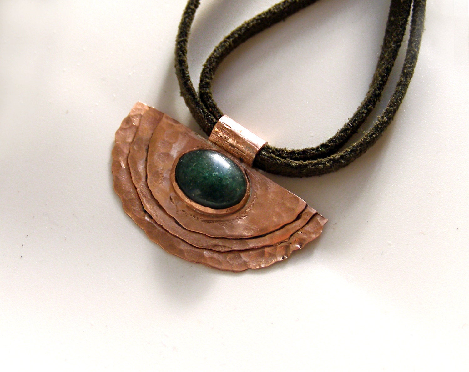 Semicircle multi layered copper pendant with green oval avanturine.