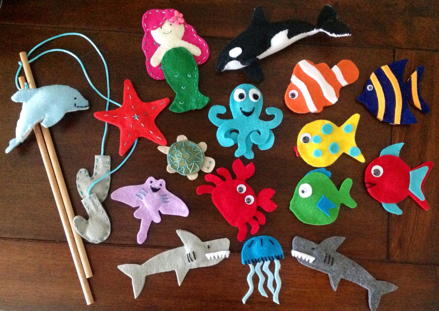 Magnetic fishing game. Felt sea creatures, fish, killer whale, dolphin, shellyfish, sharks, crab, stingray and mermaid. Party favors.