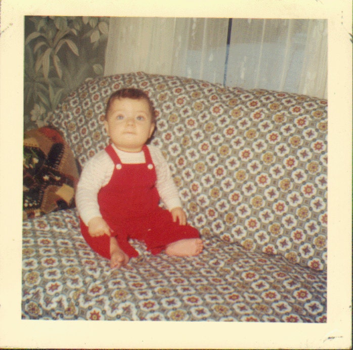 Vintage Photo of a Cute Little Barefoot Boy Sitting on a Couch