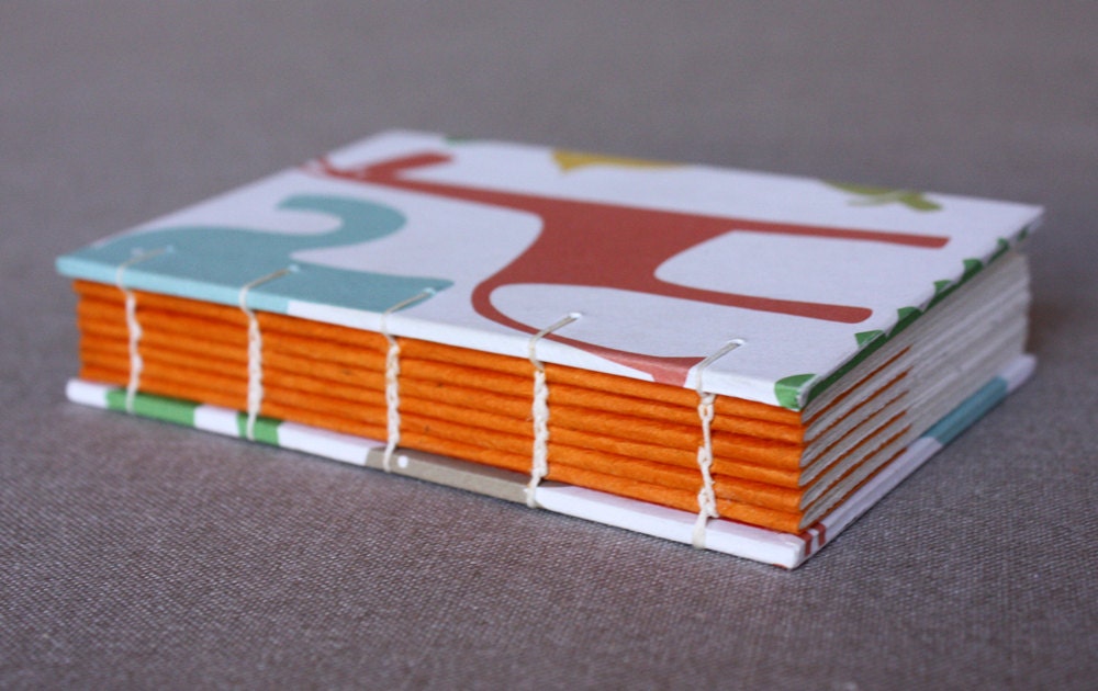 Small journal or baby shower guestbook with colorful animal print covers