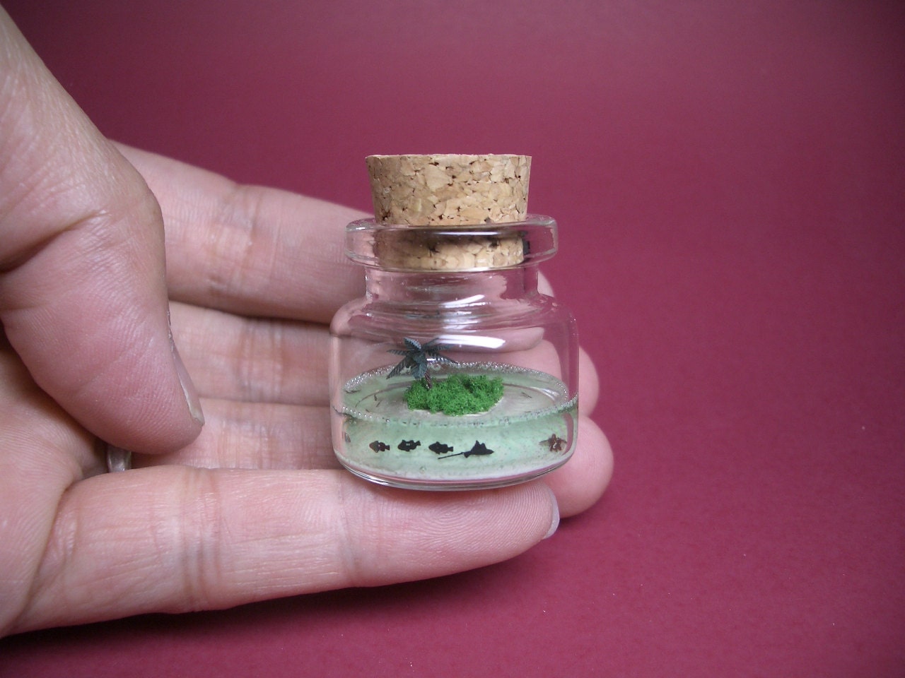 Heart island with a palm tree, there are many fish and a turtle around it in a tiny bottle  EG