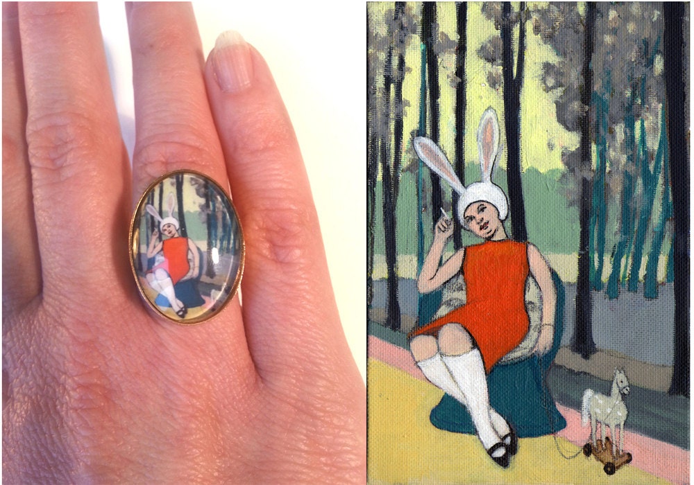 gold colored ring with painting 'cigarette break'.