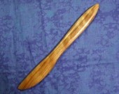 Hand carved spreader in two toned curly cherry wood
