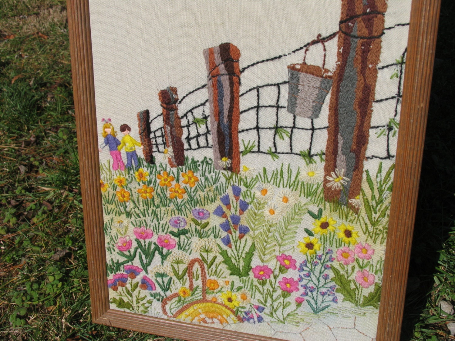 Wall Hanging Framed Yarn Art Needlework A field of wildflowers, a boy and girl along a fence line