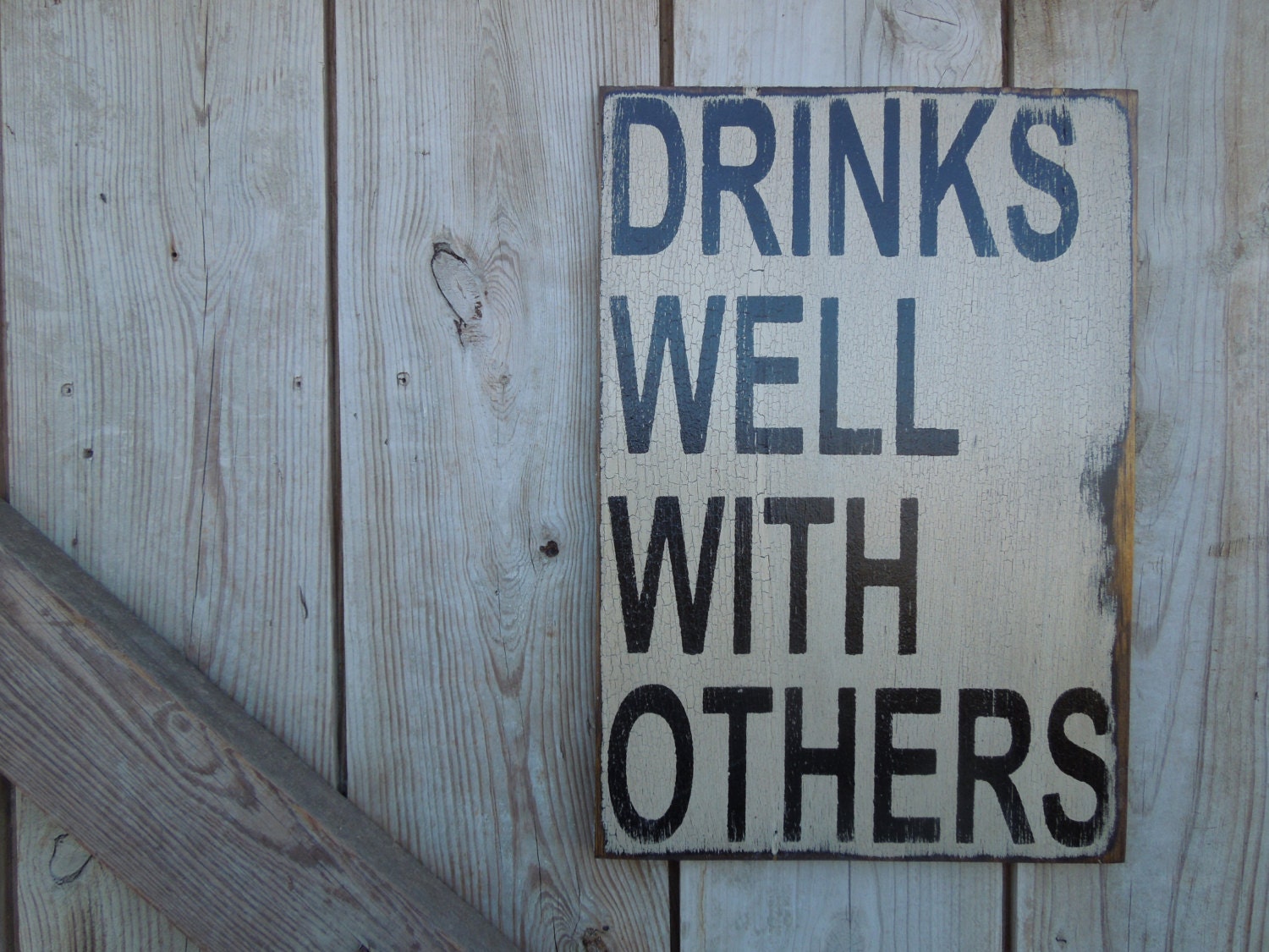 Drinks well with others sign made from reclaimed plywood