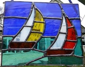 Stained glass sailing boats on ocean suncatcher