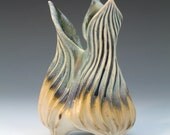 Carved porcelain vessel in green, tan & white