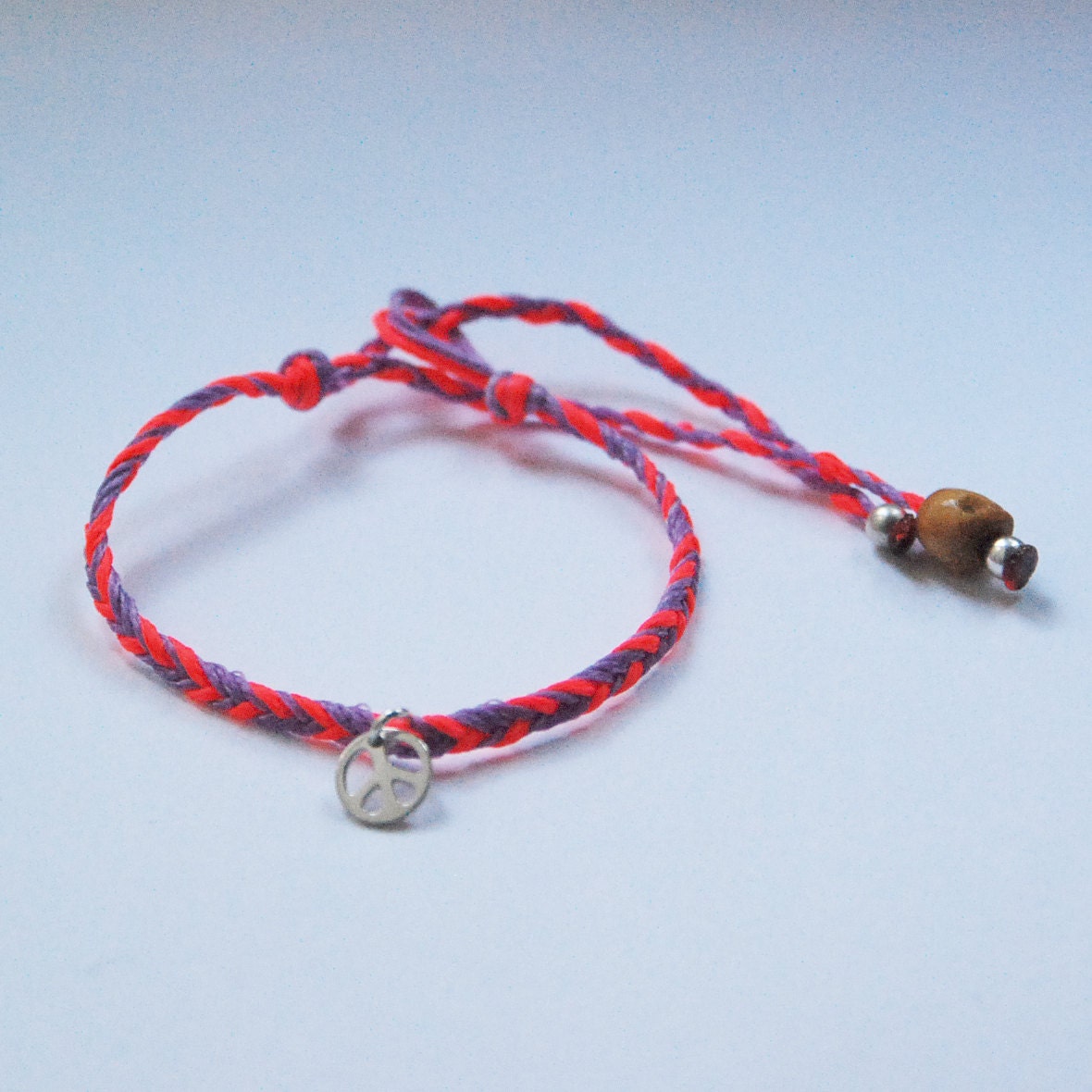 Sterling silver peace charm bracelet on braided cord