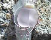 Wire Wrapped Sea Glass Necklace with glass beads. Clear and pink sea glass necklace with mother of pearl beads and a trumpet flower