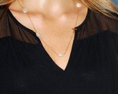 Sideways Gold Cross With Shimmering White Coin Pearls