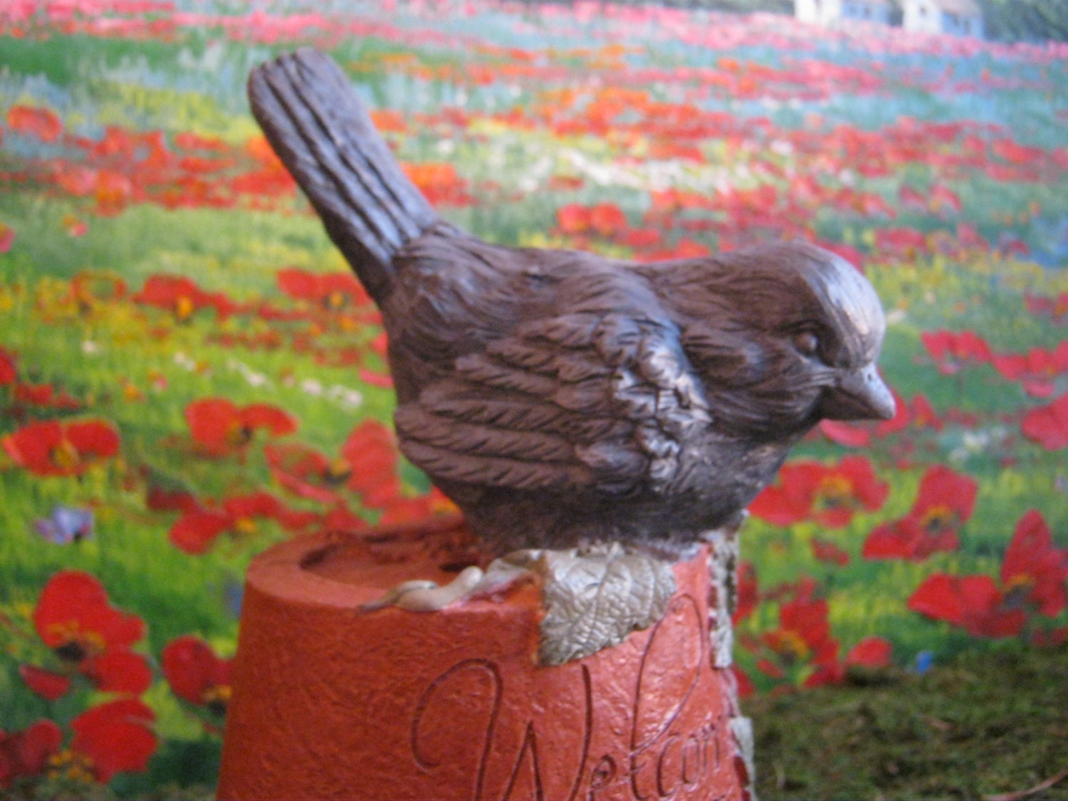 Bluebird In The Garden, Plant Pot With Blue Bird Welcomes Visitors.