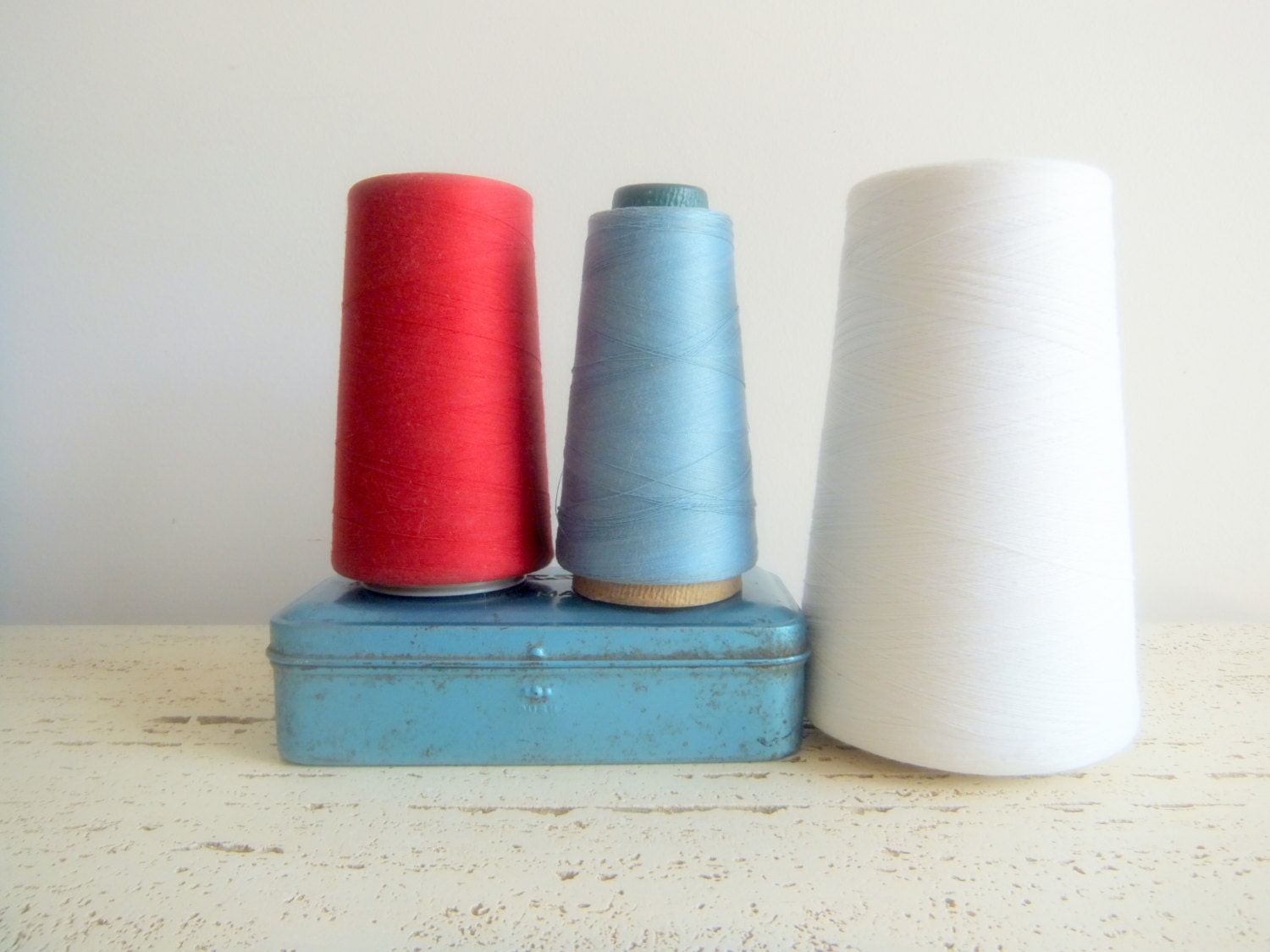 Red, White and Blue Thread Cones with Blue Metal Box